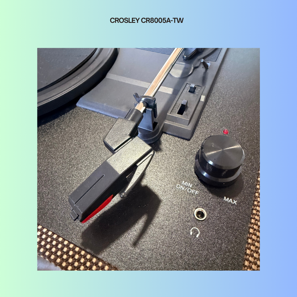 Close-up of a Crosley CR8005A-TW turntable's power knob and needle lever.
