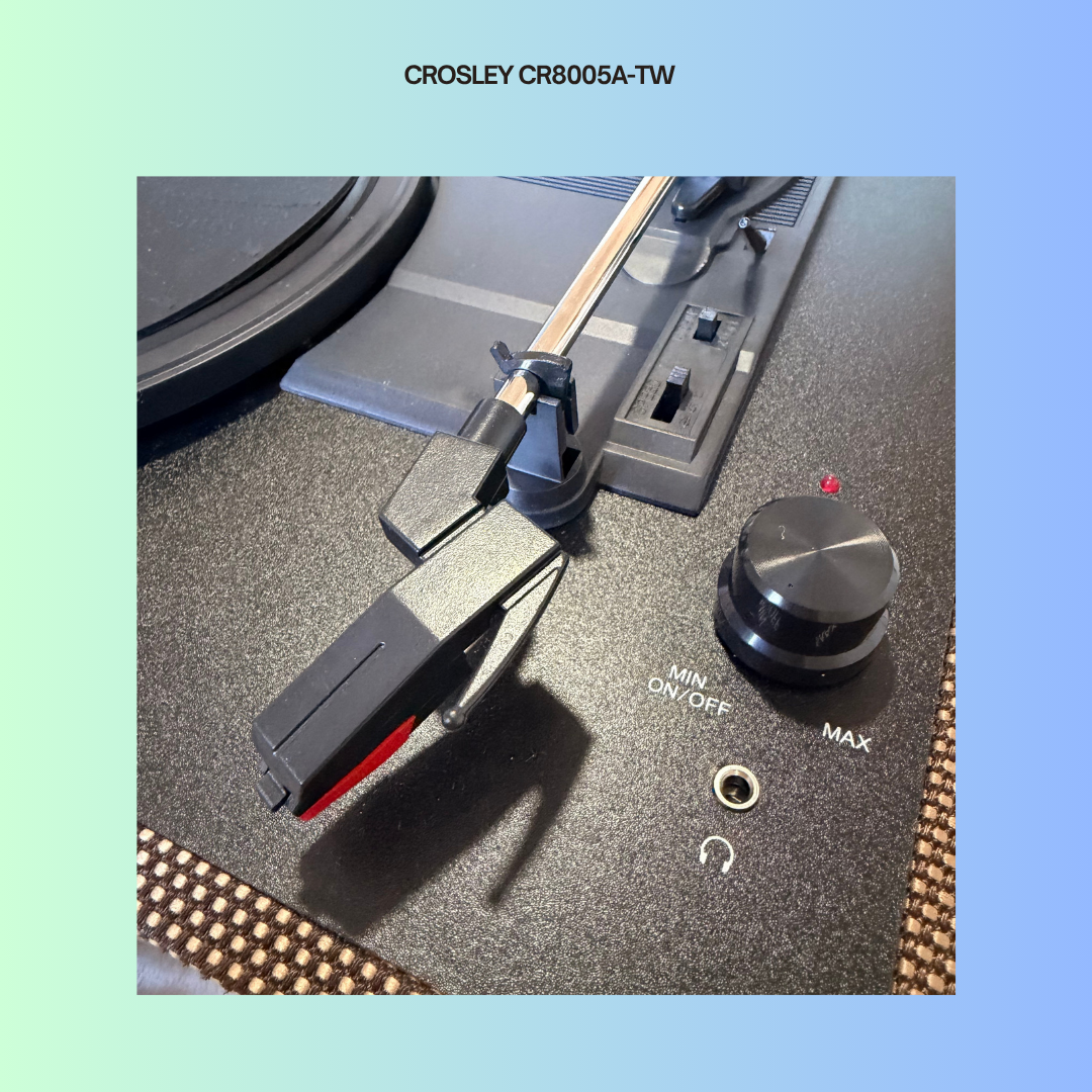 Close-up of a Crosley CR8005A-TW turntable's power knob and needle lever.