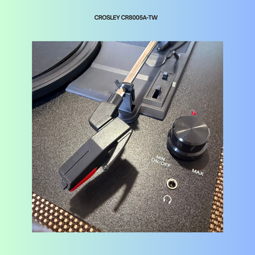Close-up of a Crosley CR8005A-TW turntable's power knob and needle lever.