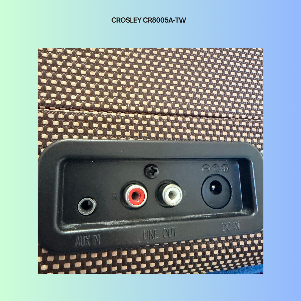 Back panel of a Crosley record player with audio connectors on a gradient background