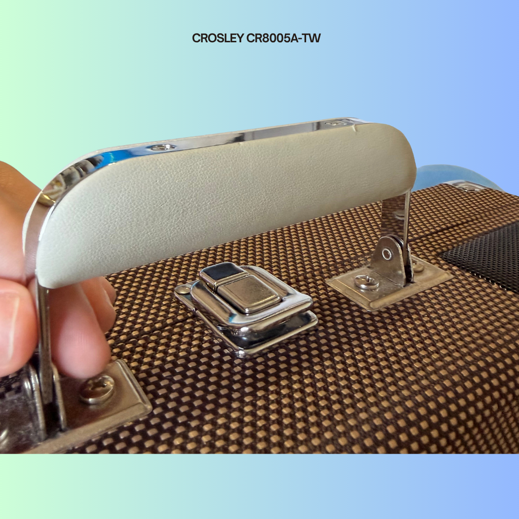 Close-up of a Crosley CR8005A-TW suitcase handle with minor cosmetic wear.