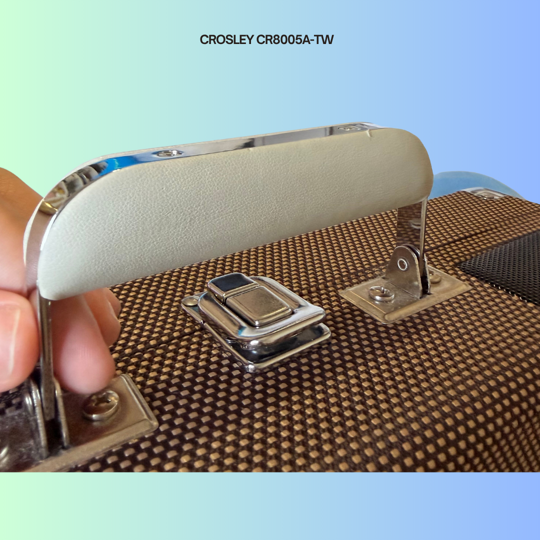 Close-up of a Crosley CR8005A-TW suitcase handle with minor cosmetic wear.